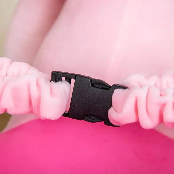 Close-up of plush pink safety buckle on children's rocking horse elephant toy