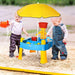 Toddlers playing at a 2-in-1 sand and water activity table with a yellow umbrella outdoors