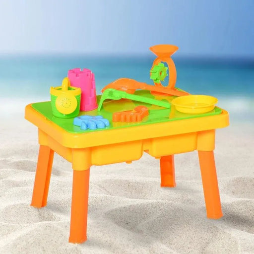 Colorful 2-in-1 sand and water sensory play table set on a sandy beach