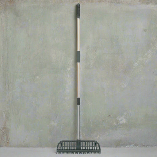 2-in-1 telescopic rake with adjustable handle and nylon bristles on gray background