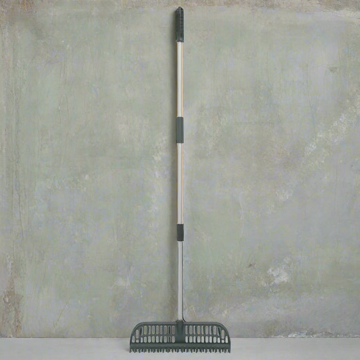 2-in-1 telescopic rake with adjustable handle and nylon bristles on gray background