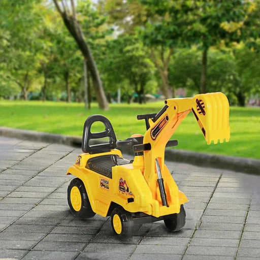 Yellow toddler ride-on excavator toy with bucket, outdoor park setting, foot-to-floor digger