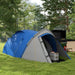 Blue and grey two-person dome tent with front vestibule set up outdoors on grass
