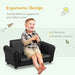 Smiling child sitting on a black 2-piece kids sofa set with ergonomic design text.