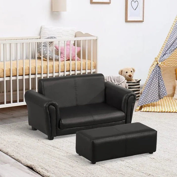 Black 2-piece kids sofa set with footstool in a nursery with crib and play tent