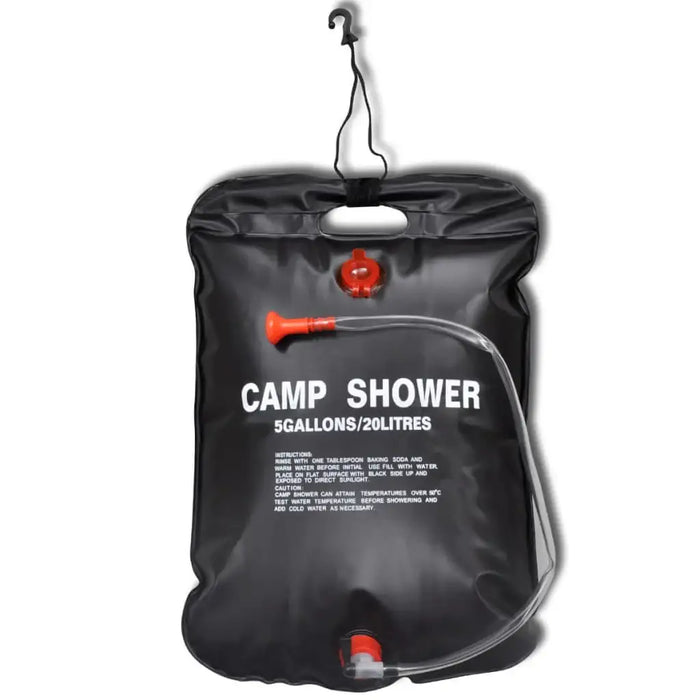Black 20L solar camp shower bag with hose and nozzle, labeled Camp Shower, hanging on hook