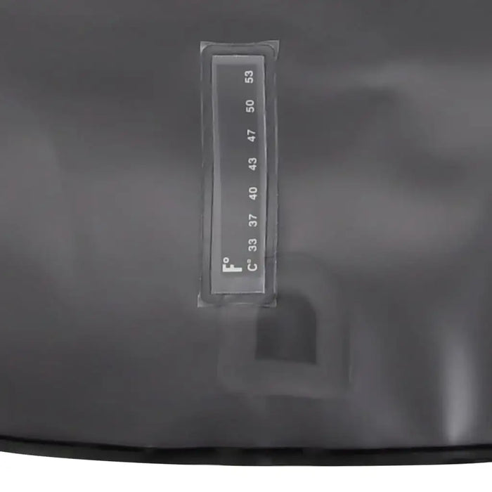 Close-up of temperature gauge on a black solar camping shower bag for outdoor use
