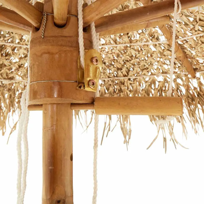 Close-up of bamboo pole and hand-woven roof on tropical banana leaf garden parasol