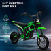 Green 24V kids electric dirt bike with thickened metal frame on dark background