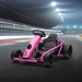 Pink 24V kids electric drift go kart on a race track at night