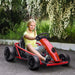 Girl driving red 24V kids electric drift go kart outdoors with flowers in background