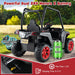 Black kids ride-on car with red wheels, roll cage, dual 24V motors, and 24V 5Ah battery outdoors