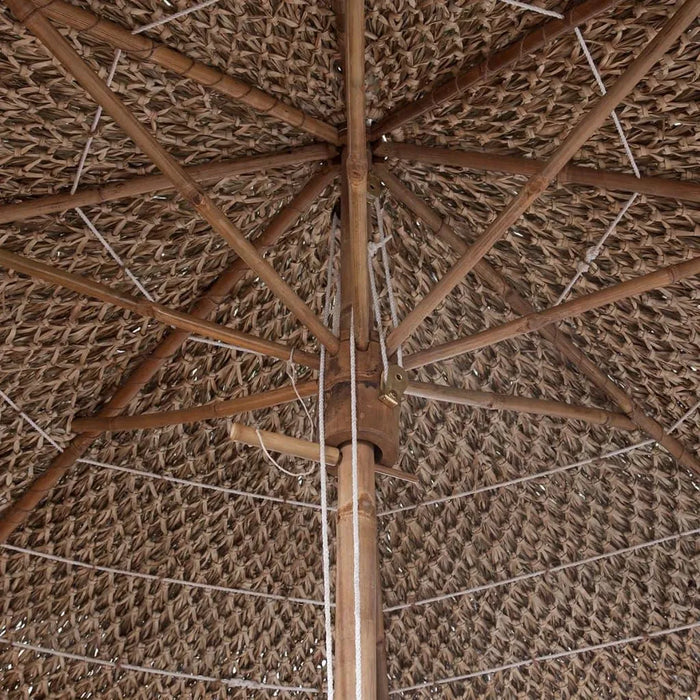 Close-up of hand-woven bamboo garden parasol with natural woven roof and bamboo pole