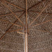 Close-up of hand-woven bamboo garden parasol with natural woven roof and bamboo pole