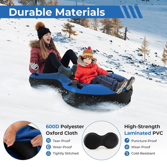 Two people sledding down a snowy hill on a durable blue and black inflatable snow tube for adults and kids