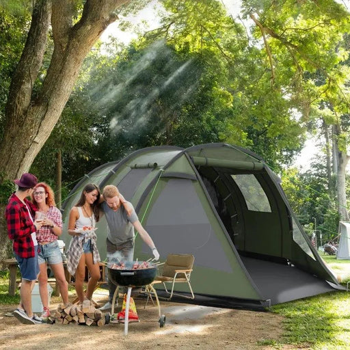 Group camping near green dome tent with two rooms, grilling outdoors under trees