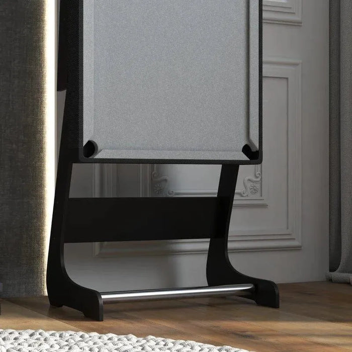 Compact grey pool table upright for storage in a modern games room with wood flooring