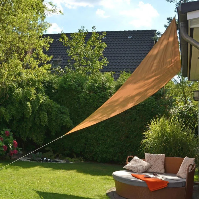 Beige triangular sun shade sail for UV protection over garden patio seating
