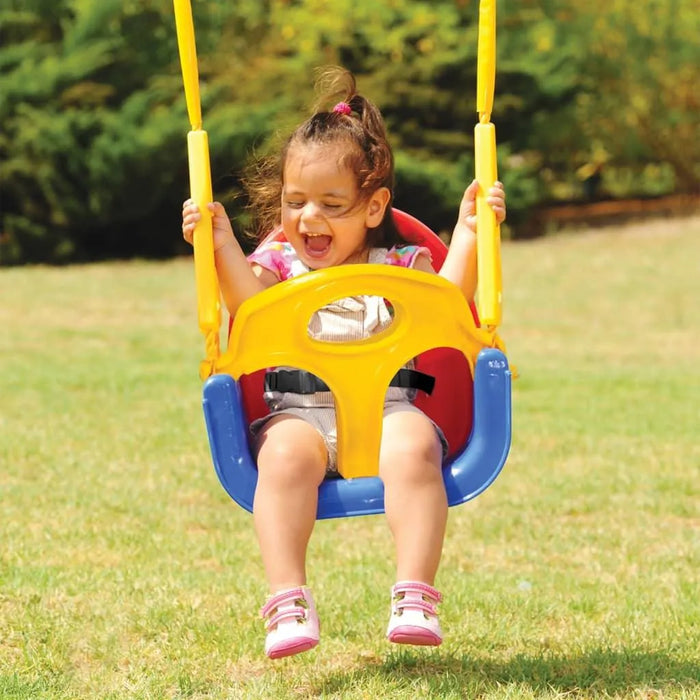 Smiling child on a colorful 3-in-1 swing seat with safety belt in a sunny outdoor park
