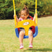 Smiling child on a colorful 3-in-1 swing seat with safety belt in a sunny outdoor park