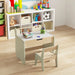Children's desk with chair in a room filled with toys