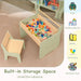 Children's wooden table and chair set with colorful building blocks on a beige surface.