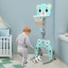 Child playing with a blue bear-shaped basketball hoop in a nursery.