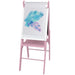 Pink wooden kids easel with watercolor painting on paper roll