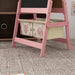 Pink kids' 3-in-1 easel with animal-themed storage baskets in a playroom
