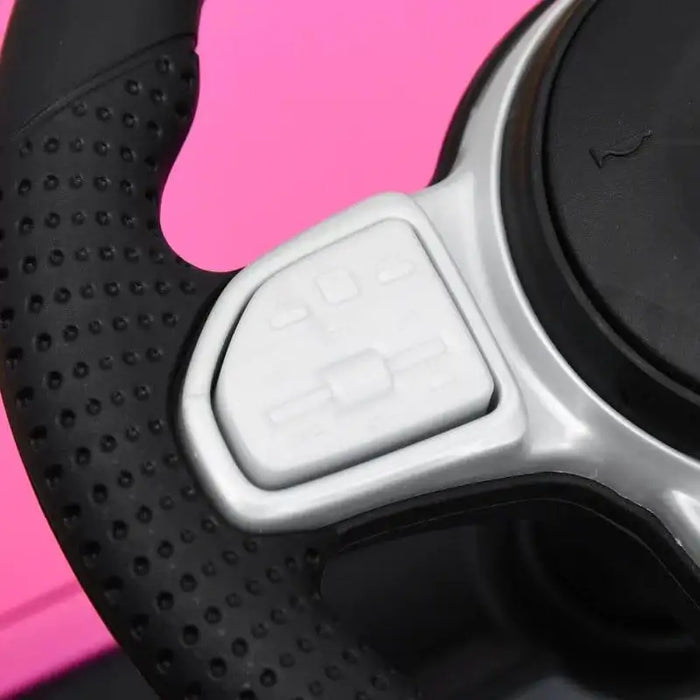 Close-up of black steering wheel with white buttons on pink kids Mercedes toy car