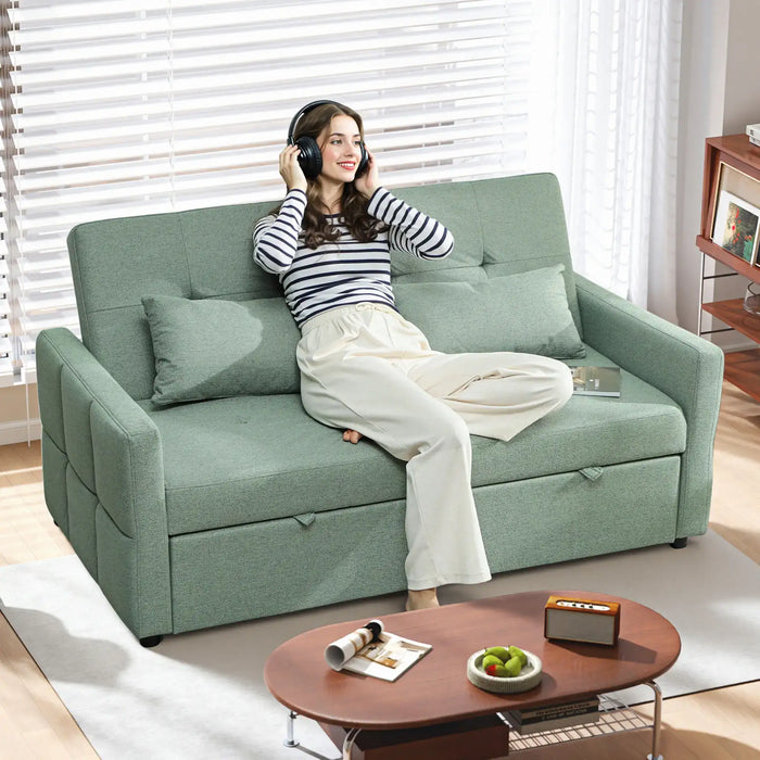 Woman sitting on a green sofa in a living room with a coffee table and decor items.