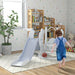Toddler in playroom with 3-in-1 space-themed swing, slide, and basketball hoop set