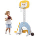 Child playing with a toy basketball hoop and balls on a white background