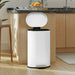 White trash bin with open lid in a kitchen setting