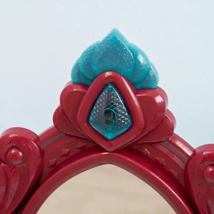Red and blue plastic crown detail on kids dressing table mirror top
