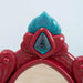 Red and blue plastic crown detail on kids dressing table mirror top