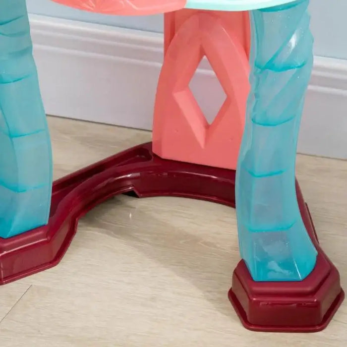 Close-up of blue plastic legs and red base of kids dressing table on light wood floor