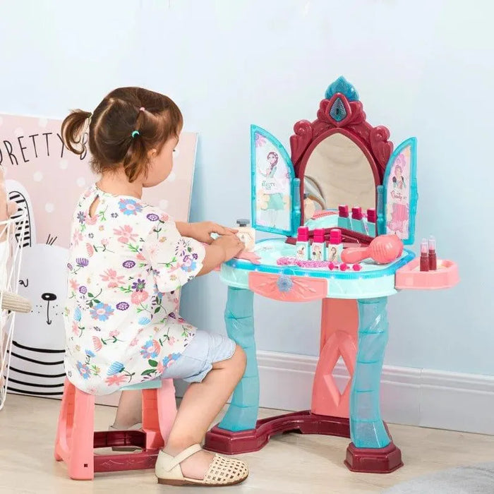 Child playing at colorful kids dressing table with stool, toy mirror and pretend cosmetics