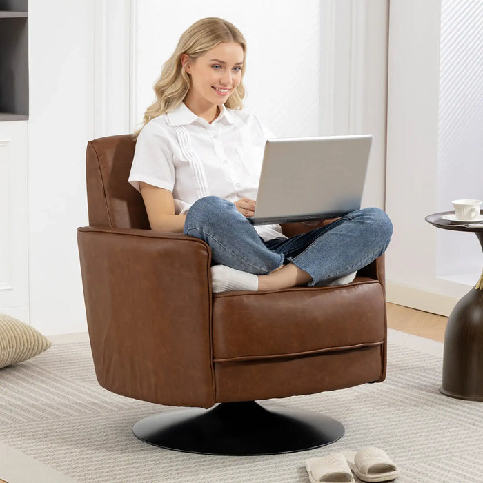 Woman using a laptop in a brown leather armchair in a modern living room.