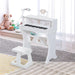 White kids piano keyboard with stool and microphone in a bright playroom