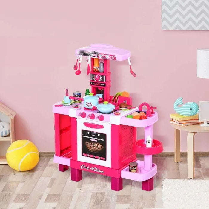 pink kids kitchen playset with oven, stove, sink, utensils and toy food in a playroom