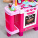 Pink kids kitchen playset with toy oven, stove, pots, cups, and utensils on gray carpet
