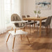 Modern high chair in a dining room with wooden table and chairs.