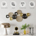 Decorative wall art with metallic circular designs on a white wall, featuring icons and text about product qualities.
