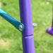 Close-up of purple and blue metal frame on children's garden swing set outdoors