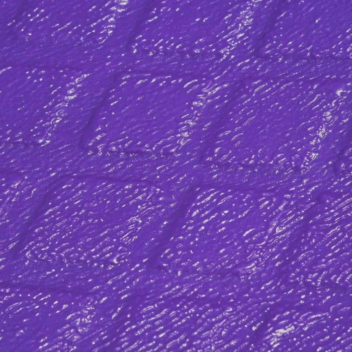 Close-up of a textured purple plastic surface with diamond pattern.