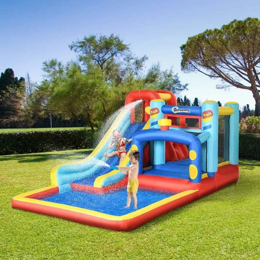 Kids playing on a colorful inflatable water park bouncy castle with slide, pool, and climbing wall outdoors.