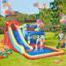 Kids playing on inflatable water park with slide, pool, bouncy castle, and balloons outdoors