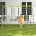 Girl on 4-in-1 kids swing and climbing set with green swings and ladder in backyard