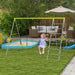 Child on 4-in-1 kids swing and climbing set with net in backyard garden